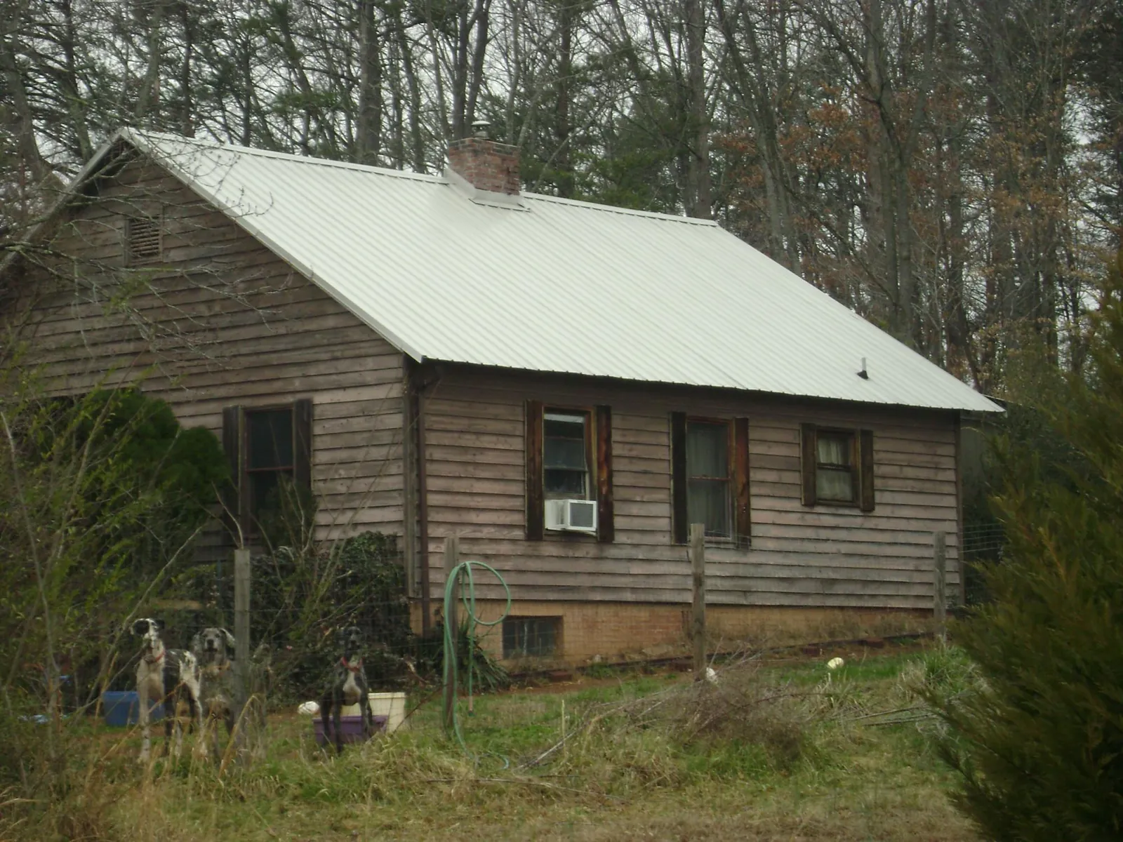 White metal roof on an old wood sided farmhouse, from a Asphalt Shingle Roof Repair job in Nortonville